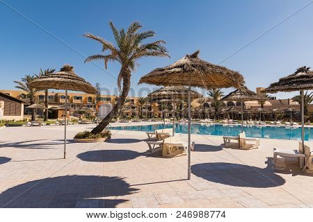 Tunisian Beach With Sun Umbrellas, Outdoor Swimming Pool, Blue Sky