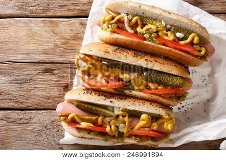 Traditional Chicago Style Hot Dog With Mustard, Vegetables And Sauce Close-up. Horizontal Top View