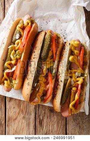 Delicious Chicago Style Hot Dog With Mustard, Vegetables And Relish Close-up. Vertical Top View