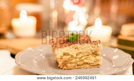 Tiramisu By Candlelight, Romantic Date In Italy, Tiramisu Dessert On A Porcelain Plate
