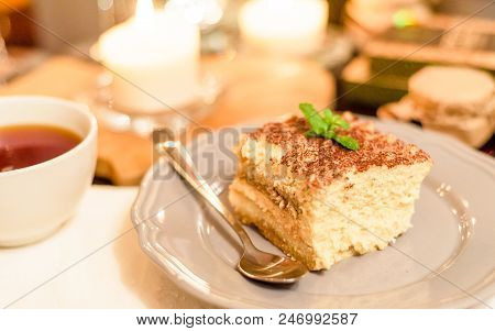 Tiramisu By Candlelight, Romantic Date In Italy, Tiramisu Dessert On A Porcelain Plate