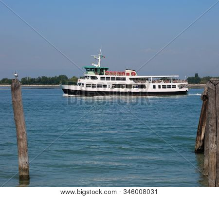 Venetian Water Bus Also Called Vaporetto In Italy To Transport Tourists To Venice While Mooring At T