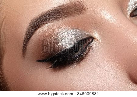 Beautiful Woman With Professional Makeup. Closeup Macro Of Woman Face With Cat-eye Make-up. Fashion 