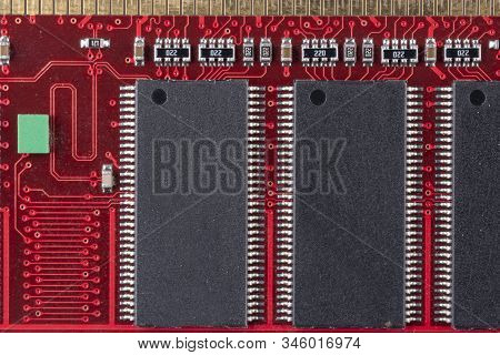 Red Microcircuit Of Old Computer Random Access Memory With Black Microcircuits, Top View, Macro Phot