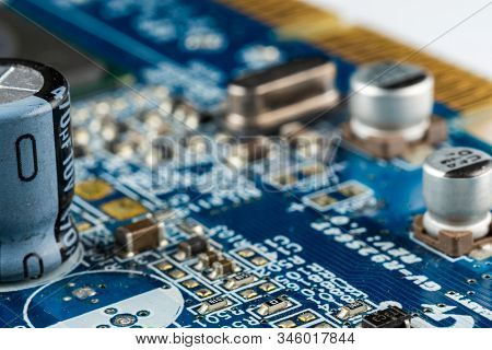 Computer Blue Motherboard With Microchips, Capacitors And Various Electronic Components, Side View, 
