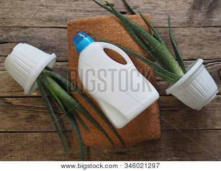 The Concept Of Eco-friendly Natural Detergents. A Plastic White Bottle Of Detergent On Bath Linen Wi