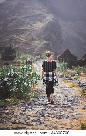 Woman Hiker On The Picturesque Coastal Cobbled Route. The Road Joins The Towns Of Cruzinha, Fontainh