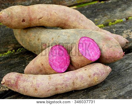 Sweet Potatoes On Wooden Table Close Up