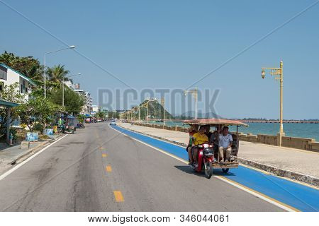 Prachuap Khiri Khan, Thailand - February 9, 2019: Promenade by the sea with monkey hill at background in Prachuap Khiri Khan, Thailand.
