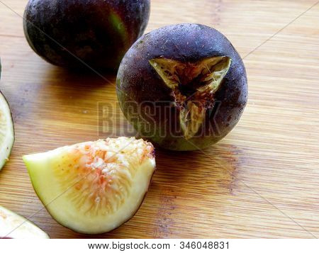 Figs Cut And Whole On A Wooden Table
