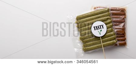 Tasty Vegan Food. Pack Of Meatless Sausages Lying On White Table, Panorama, Empty Space