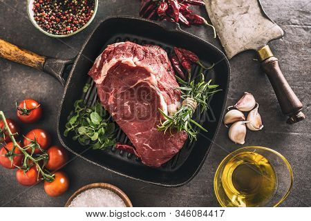 Beef Ribe Eye Steak In Grill Pan With Rosemary Oregano Salt Pepper Spices Garlic And Tomatoes