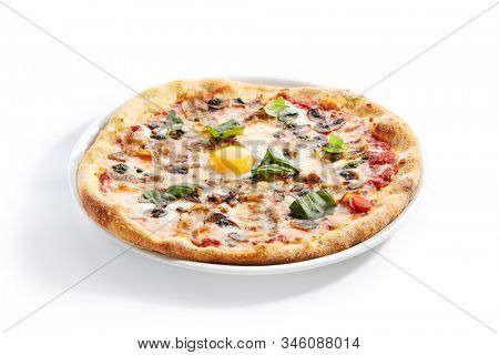 Pizza with mushrooms, bacon and egg on white restaurant plate isolated. Italian carbonara pizza with mushrooms, tomatoes and fresh green basil closeup