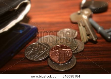 Coins, Wallet, Phone And Keys Laying On Table