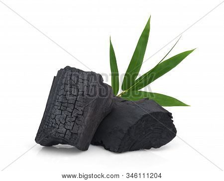 Wood Charcoal With Bamboo Leaf Isolated On White Background