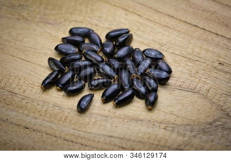 Custard Apple Seeds On Wooden Background. Sugar Apple.