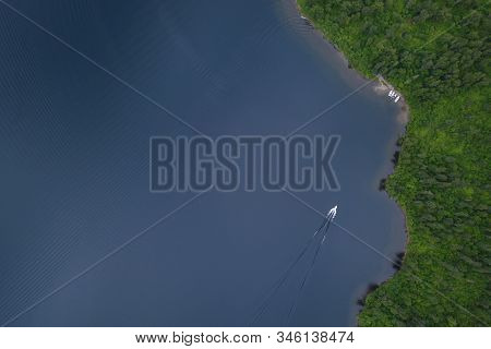 Aerial View Of The Teletskoe Lake With Boats Near The Shore And One Boat Sailing To The Pier With Gr