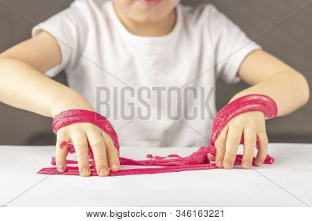 Kid Plays With A Homemade Pink Glitter Slime. Child  Hands Stretch Slime Toy. Make Slime At Home. Th