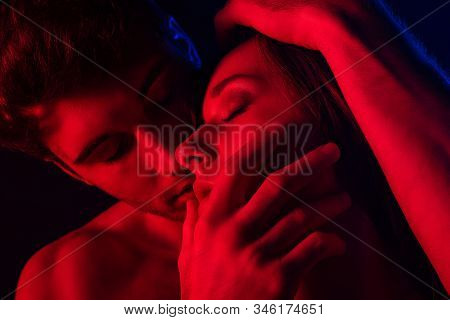 Passionate Undressed Sexy Man Kissing Woman In Red Light