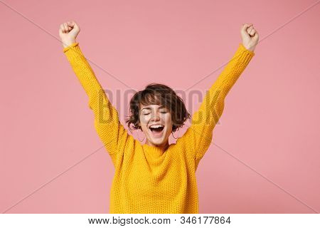 Happy Young Brunette Woman Girl In Yellow Sweater Posing Isolated On Pastel Pink Background Studio P