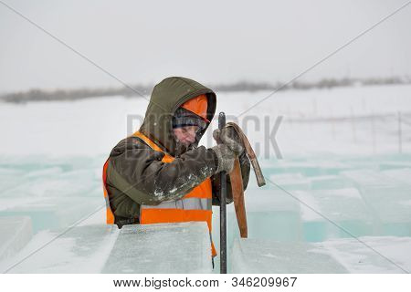 Slinger In Orange Helmet On Shipment Of Ice Blocks