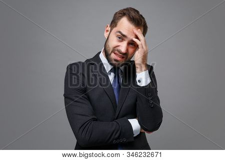 Preoccupied Tired Young Bearded Business Man In Classic Black Suit Shirt Tie Posing Isolated On Grey