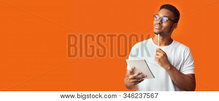 Pensive Redactor. Dreaming Afro Man In Glasses Taking Notes, Writing Ideas, Looking At Copyspace, Or