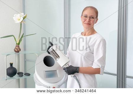 Cosmetologist Standing In Rubber Gloves Doing Endospheres Therapy