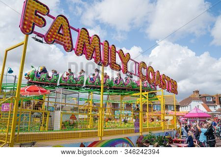 Dymchurch England - August 19 2019; Amusement Park Family Coaster Ride With People Riding And Watchi