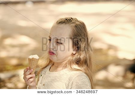 It Leaves A Bad Taste In The Mouth. Cute Little Girl Dislike Taste Of Ice Cream. Small Child Licking
