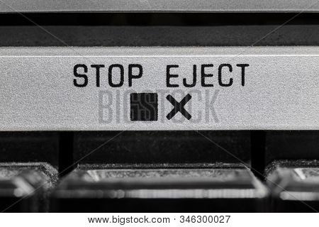 Macro close up photograph of vintage boombox stop and eject button detail.