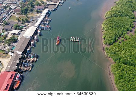 Fishing boats and port in Asia. Overfishing is environmental problem