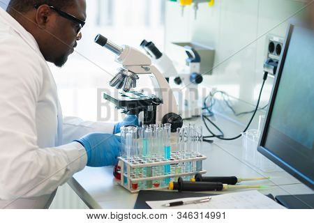 African-american Scientist Working In Lab. Doctor Making Microbiology Research. Laboratory Tools: Mi