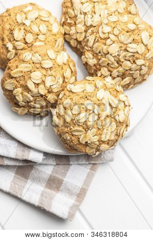 Cereal oatmeal cookies on white table.