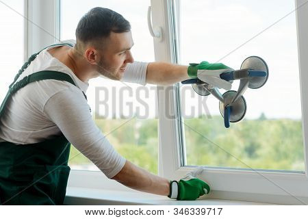 Man Is Replacing Glass In Window Using A Vacuum Lifter
