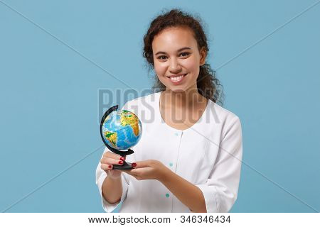 Smiling African American Doctor Woman Isolated On Blue Wall Background. Female Doctor In White Medic