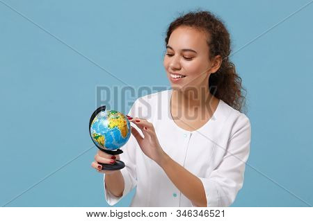 Joyful African American Doctor Woman Isolated On Blue Wall Background. Female Doctor In White Medica