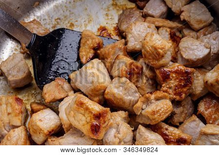 Searing Pieces Of Pork Meat Are To Get Roasted Aroma For A Hearty Stew, Goulash Or Ragout, Homemade 