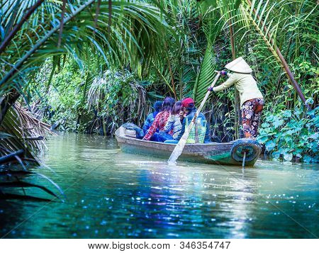 Tourist Enjoying Mekong Delta Cruise With Canoe On Vietnam
