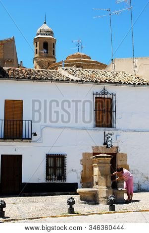 Ubeda, Spain - July 28, 2008 - Girl Taking Water From A Drinking Fountain In The Plaza Santa Lucia, 