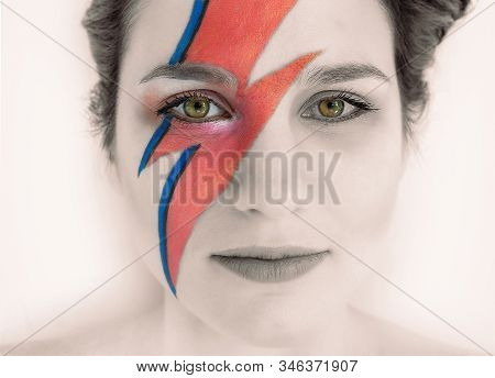 Close-up Face Of A Girl With Bright Green Eyes. Original And Creative Makeup In The Form Of Lightnin