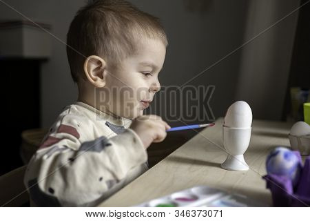 Toddler Boy Painting Easter Eggs Preparing For Holidays. Easter Tradition