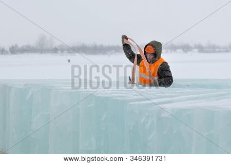 Slinger In Orange Helmet On Shipment Of Ice Blocks