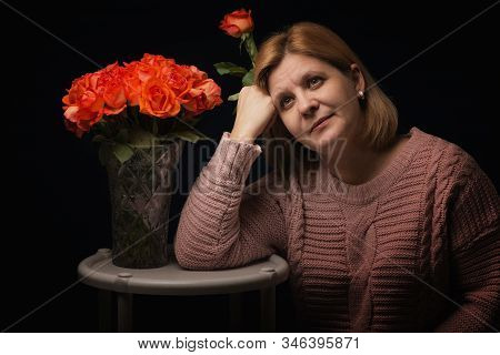 The Woman With A Bouquet Of Flowers. A Gentle Photo With Roses..
