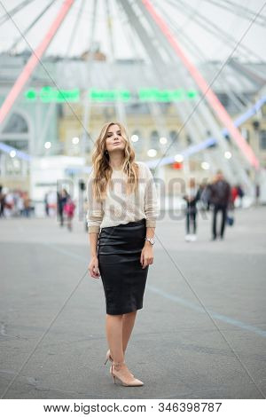 Gorgeus Blonde Woman In Leather Skirt Posing On The Ferris Wheel Background