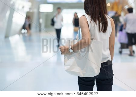 Woman Hand Holding Eco Shopping Bag In Store Background With Copy Space For Text. Environmental Prot