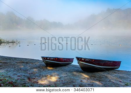 Rowboats On Foggy Beach Beside Windsor Lake In North Adams, Ma