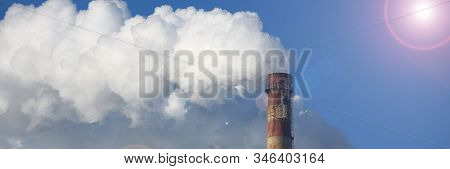 White Smoke Comes From Pipes Against Blue Sky. Problem Harmful Emissions And Air Pollution Of Centra