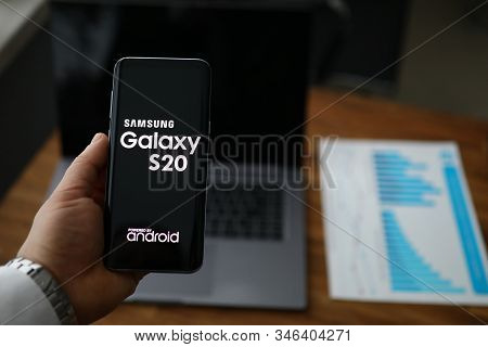 Minsk, Belarus - 20 January 2020 : Businessman Hold Samsung Galaxy S20 Smartphone In Hand. Illustrat