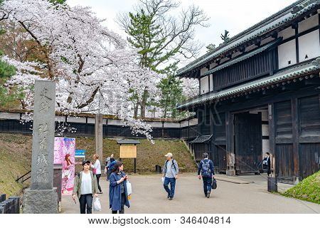 Hirosaki Park In Springtime Cherry Blossom Season Sunny Day At Otemon Gate Entrance. Visitors Enjoy 